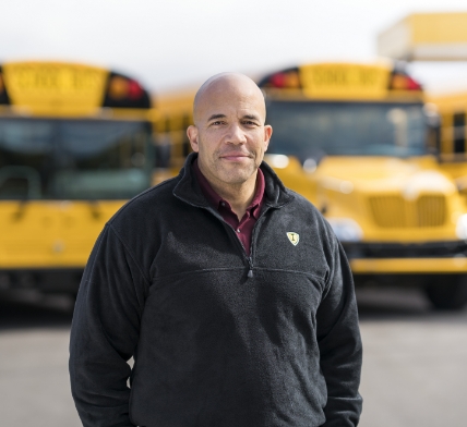 Male Bus Driver In Front Of IC Bus Fleet