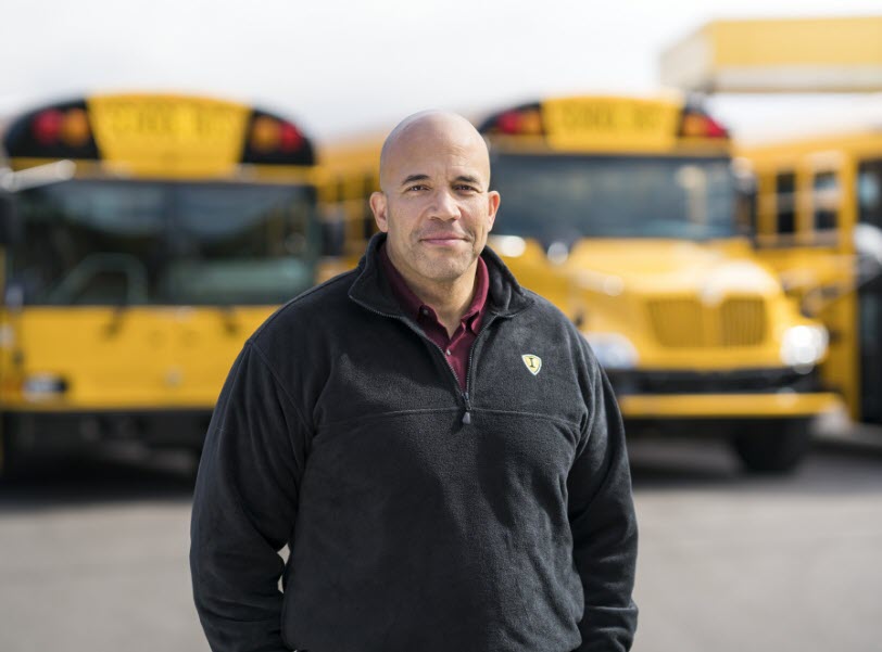 Male Bus Driver In Front Of IC Bus Fleet