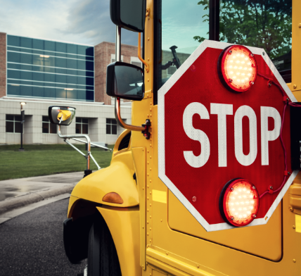 Stop sign arm on school bus