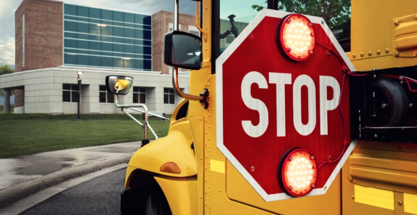 Stop sign arm on school bus