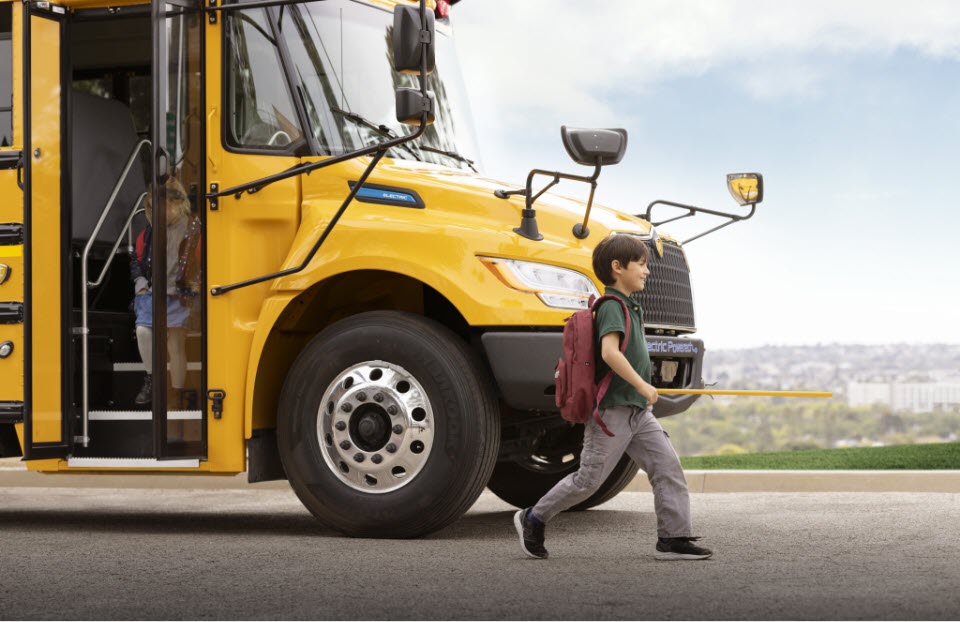 Student in front of school bus
