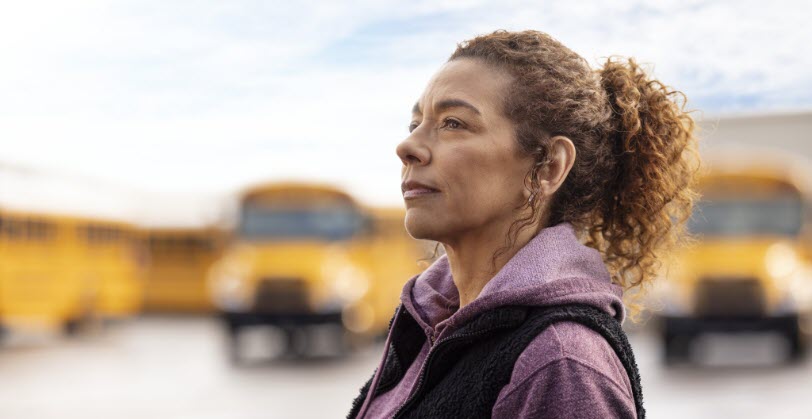 Woman standing in front of IC Bus fleet