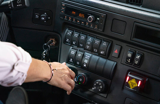 Bus instrument panel with driver touching controls