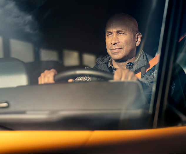 A person driving a bus