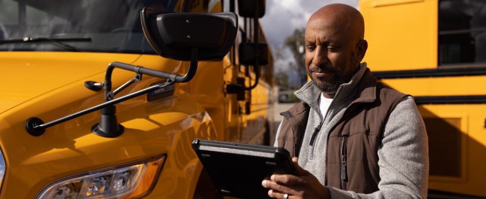 Man inspecting school bus