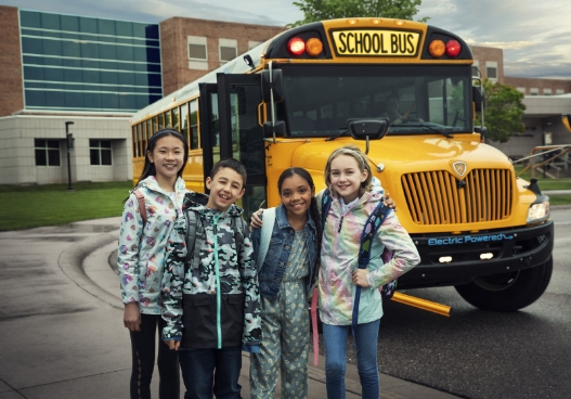 Kids in front of school bus